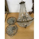 A central crystal chandelier together with two smaller bag lustre light fittings.