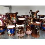 A collection of English lustre ware jugs with relief decoration, cups etc.