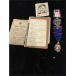 A carton of military items including ephemera and medallions.