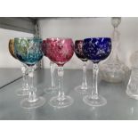 A quantity of glassware to include a set of six coloured glasses.