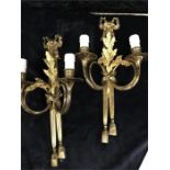 A pair of French style wall lights in brass.