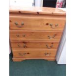 A modern four drawer pine chest.