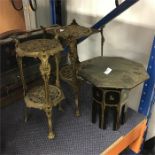 An oriental table with two plant stands.