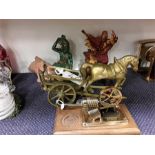 Three ornaments and a brass horse and cart together with another item.