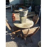 A circular garden table with four chairs.