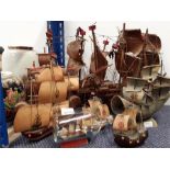 Various wooden galleons together with a ship in a bottle.