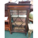 A mahogany china display cabinet with satinwood inlay.