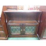 An oak glazed bookcase.