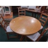 A drawleaf dining table and four chairs.
