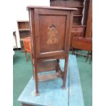 An Arts and Crafts smokers cabinet with inlaid relief to door.