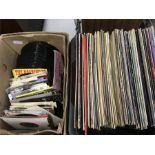 A box of singles with another of LPs.