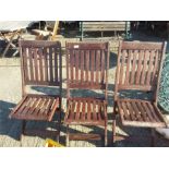 Three folding garden chairs.