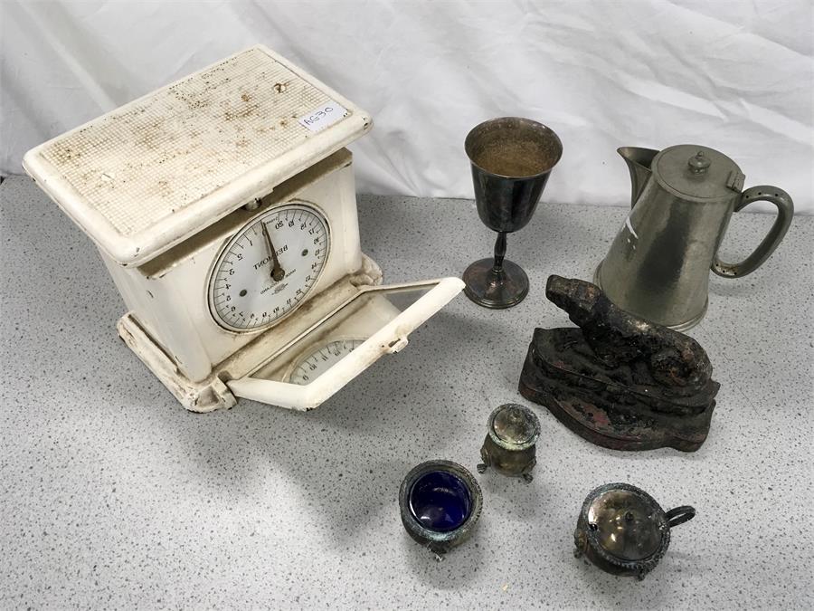 A vintage set of weighing scales, door stop and other metal items.