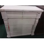 A pine five drawer chest painted white.