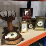 A barometer together with a selection of clocks.