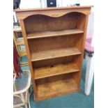 A pine three shelved open bookcase.