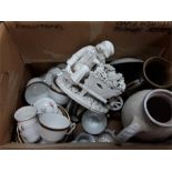 A box of various items to include an ornament, a jug and the residue of a Noritake tea set.