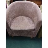 A tub chair upholstered in brown velour.