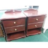 A pair of two drawer pine bedside cabinets.