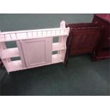 A white painted wall cupboard together with an oak magazine rack.