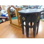 A small octagonal table with inset key designs together with a pine vanity mirror.