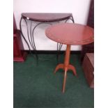 A metal framed half moon table together with a circular tripod table.