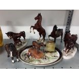 Five china horse ornaments together with a lighter, plate and metal horse.