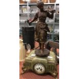 An ornamental clock designed as a bronzed lady figure standing on a marble plinth.