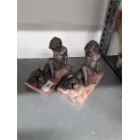 A pair of Spelter bookends modelled as cherubs with dogs on a marble base.