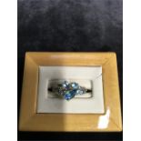 A 9ct gold ring set with blue stones.