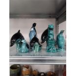 Seven blue/green glazed Poole Pottery animals.