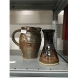 A brown pottery studio tomokue glazed jug by J Leach at Lowerdown, marked TR ML E together with a