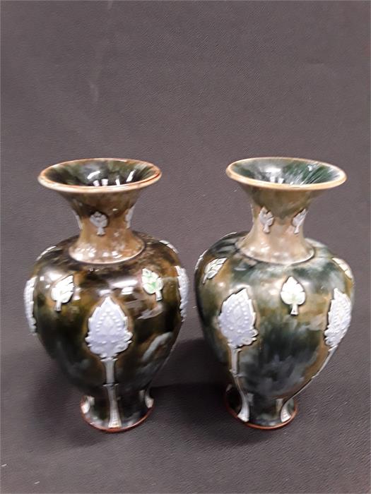 A pair of Royal Doulton green glazed Slip trailed Art Nouveau vases.