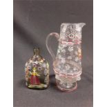 Two German pieces of enamelled glassware, a Historireich Jug dated 1667 and a bottle, floral