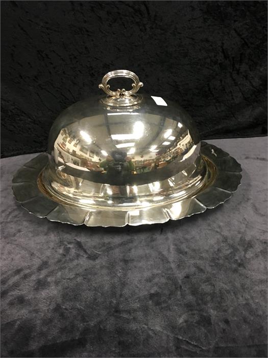 A silver plated oval meat plate and drainer recess with associated plated dome cover.