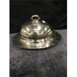 A silver plated oval meat plate and drainer recess with associated plated dome cover.