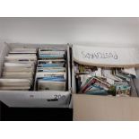 Two boxes containing a large quantity of coloured postcards.