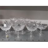 Sixteen Waterford clear cut glass drinking glasses of various forms.