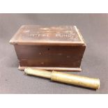 A WWII 'Spitfire Fund' box with a telescope.