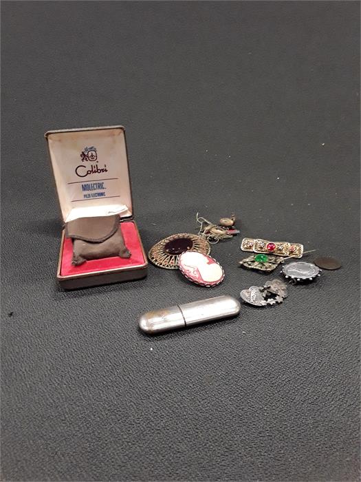 A boxed cigarette lighter together with a silver Queen Victoria brooch, other brooches etc.