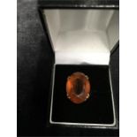 A 9ct gold dress ring with large tangerine coloured stone.