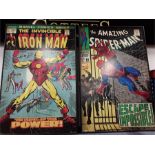 Two large framed posters depicting Iron Man and Spiderman.