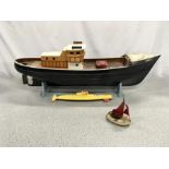 A model boat with display stand and motorised accessories.