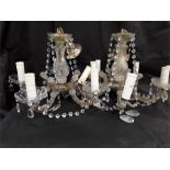 Two five branch crystal chandeliers together with 2 two branch wall hanging lights.