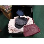 A metal safety box containing various clothing a handbag and hat.