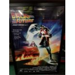 A large framed poster depicting Back to the Future.