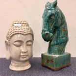 Two large glazed pottery figures depicting a horse and an oriental deity.