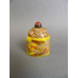 A Peking glass snuff bottle with enamelled phoenix decoration on a yellow ground, 2" high