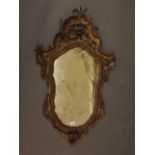 A C19th Italian carved and pierced pine wall mirror, 43" x 26"