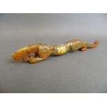 A Chinese carved hardstone ornament in the form of a dragon, 9½" long